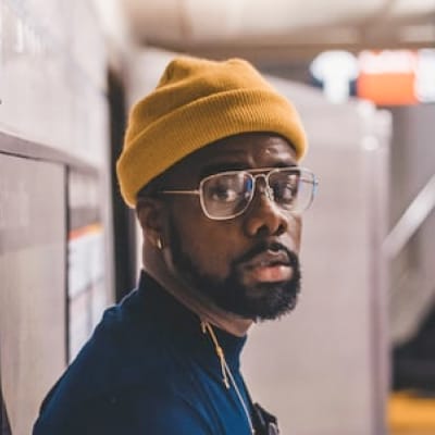 man wearing yellow beanie and glasses
