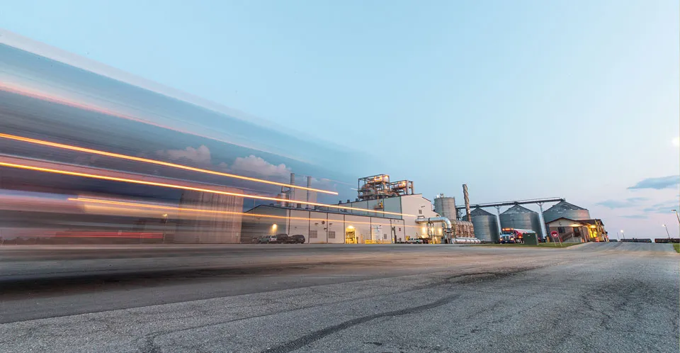 Industrial plant at dusk with light trails.