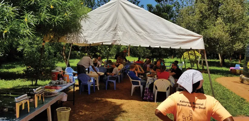 A group of people sitting under a tent