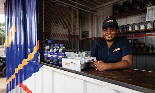 A YAZU representative sells cookstoves and fuel at a local storefront in Mozambique.