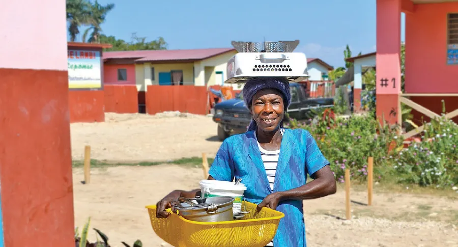 A woman carrying dishes