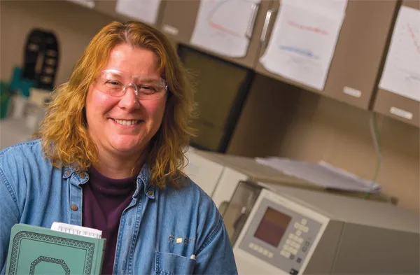 Rueter wearing glasses in a lab