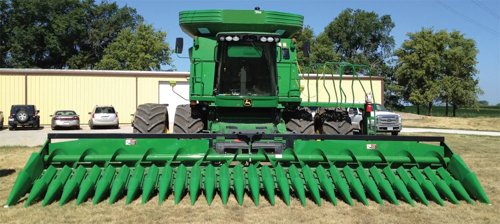 A combine with a narrow row corn head.