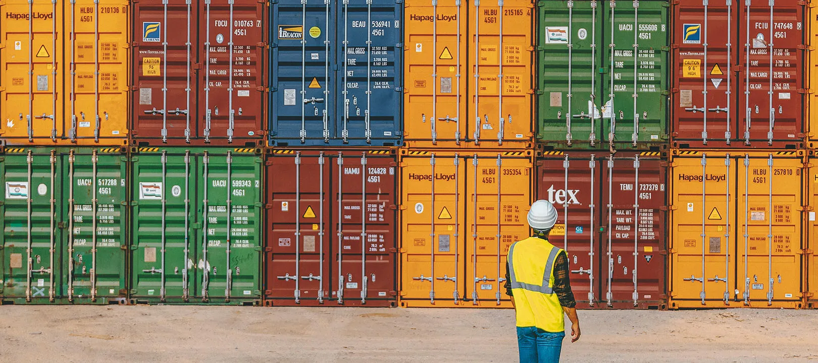 A man looking at the huge containers