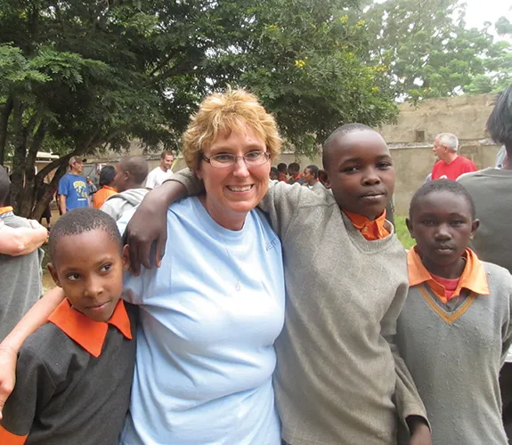 Connie Hancock with three boys outdoors