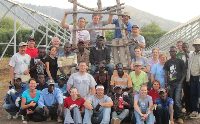 Group photo with four rows of people posing together