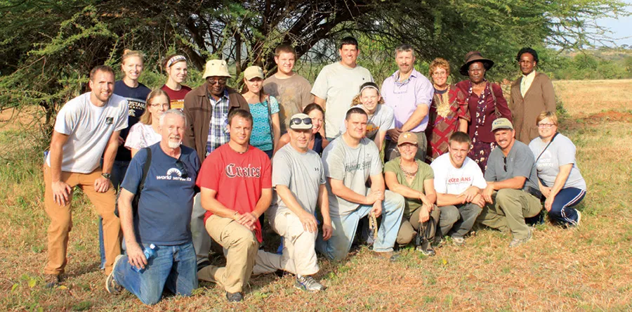 Group photo with two rows of people posing together