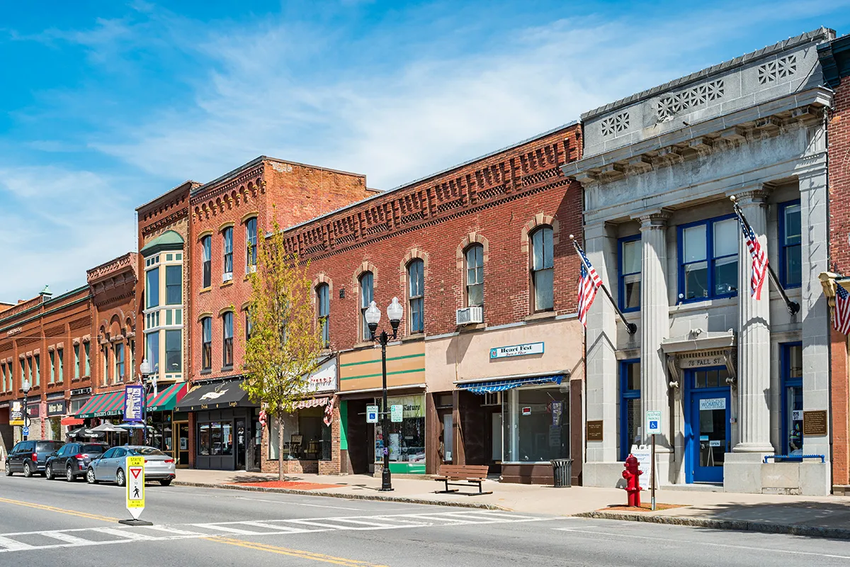Brick storefronts line a small-town street.