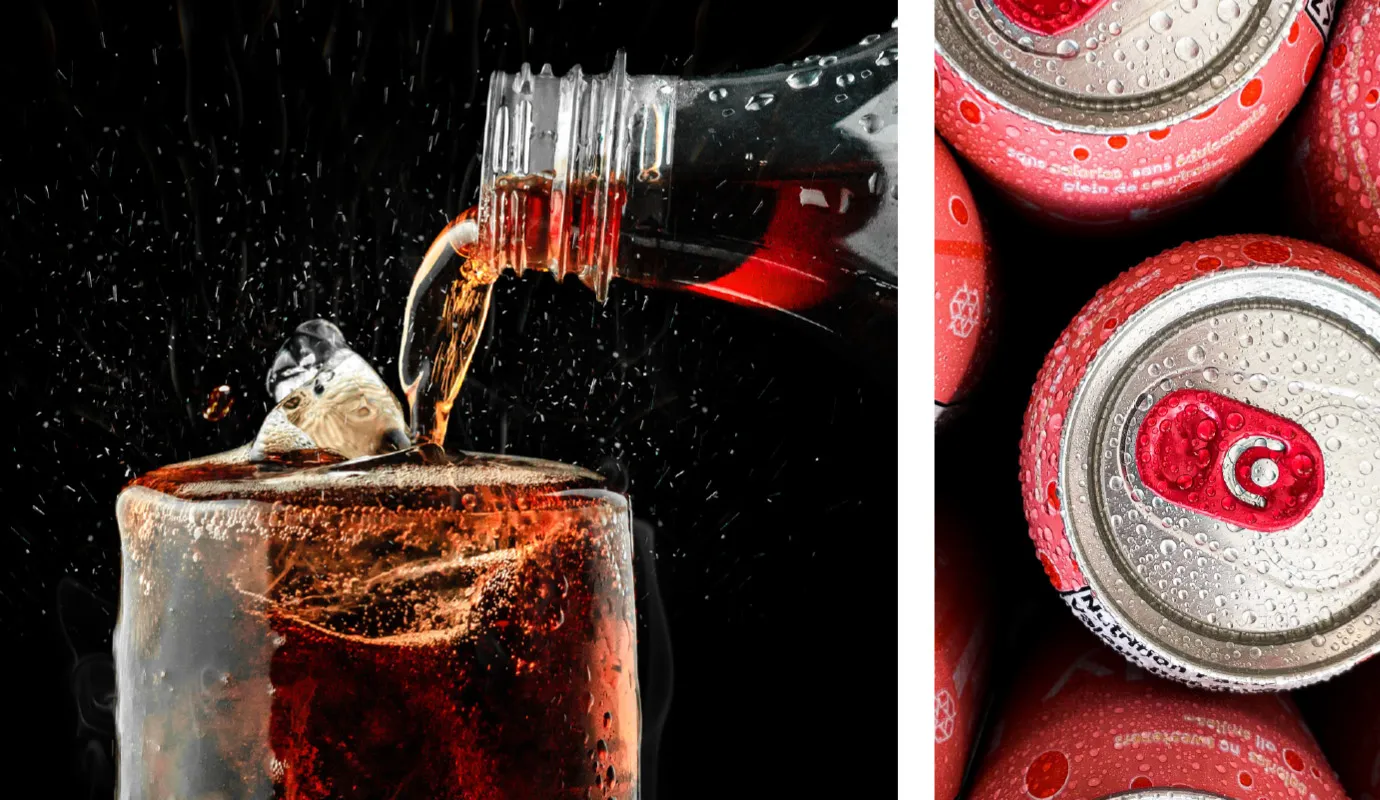 Pouring cola into a glass beside soda cans