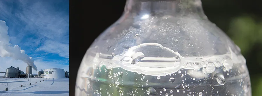 Industrial plant in snow beside a bubbly bottle.