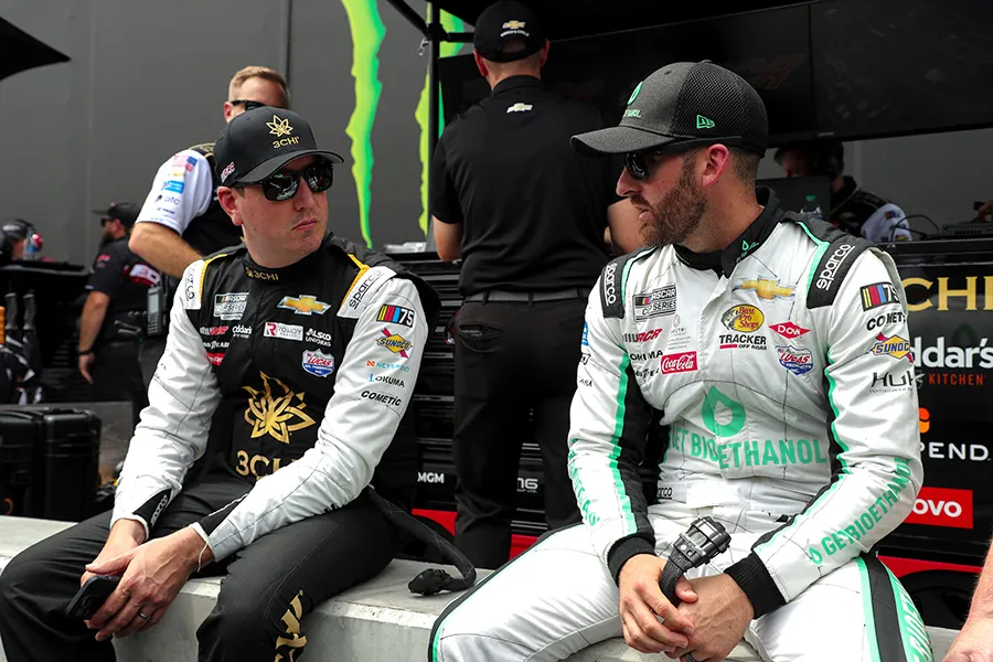Two NASCAR drivers in the pit area.