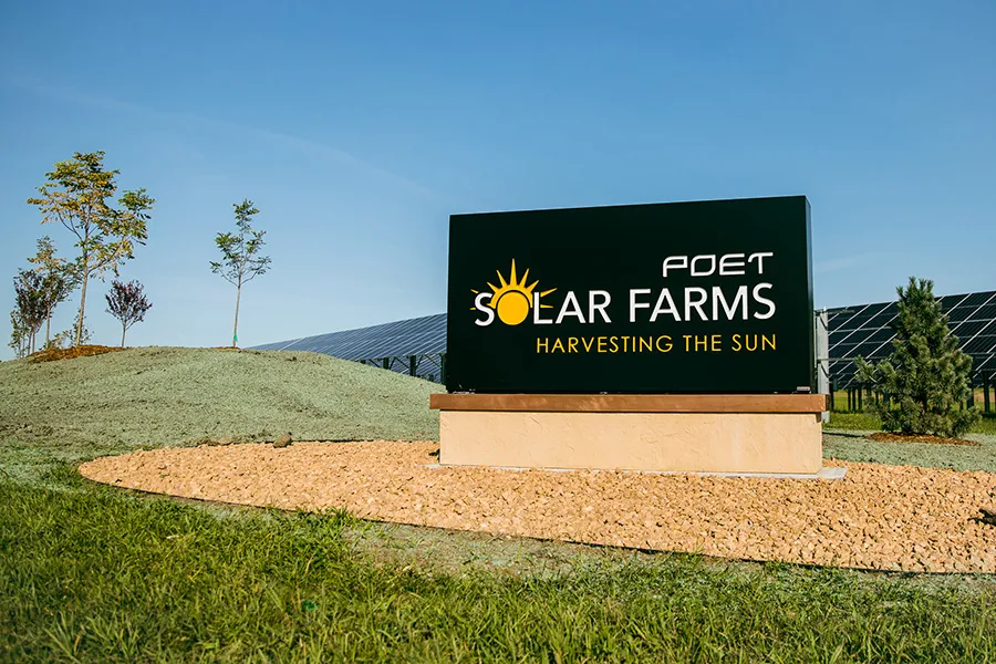 Solar Farms sign with sun logo at solar farm