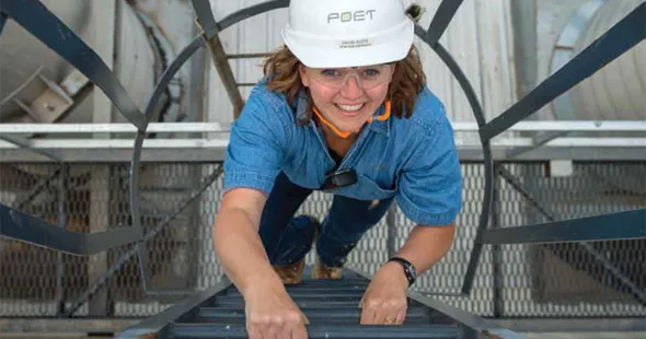 Rachel Kloos climbing a ladder at POET Bioprocessing - Chancellor