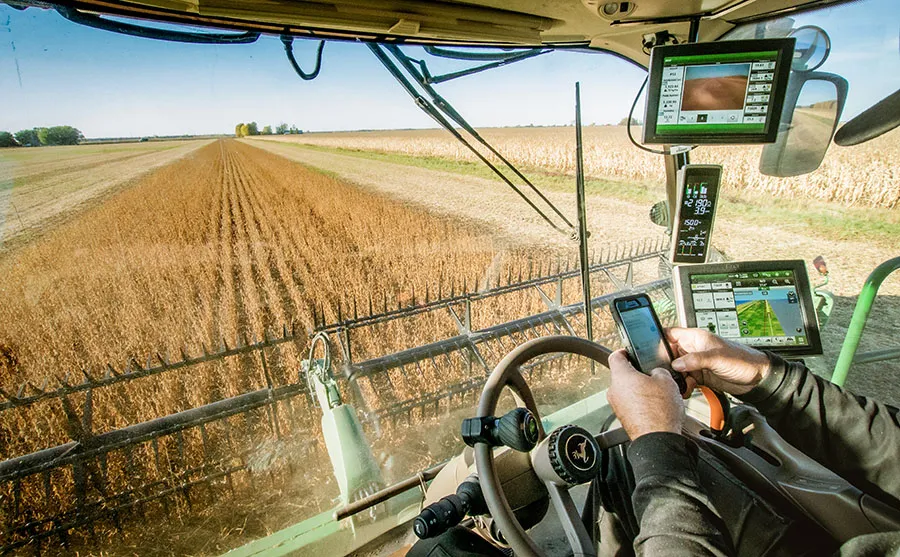 Combine harvester cab with monitor displays