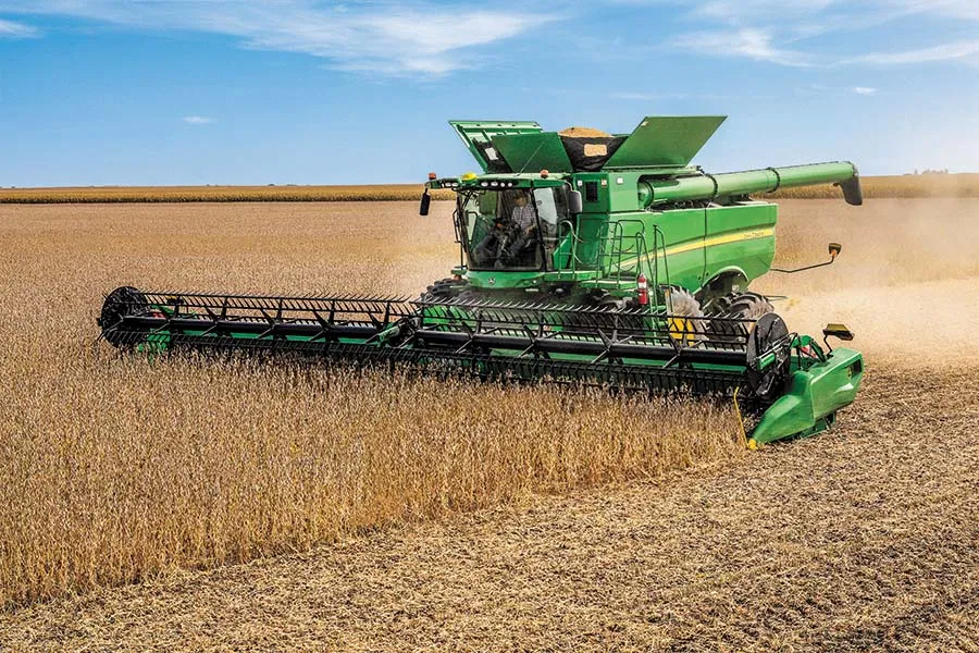 John Deere combine harvester in corn field