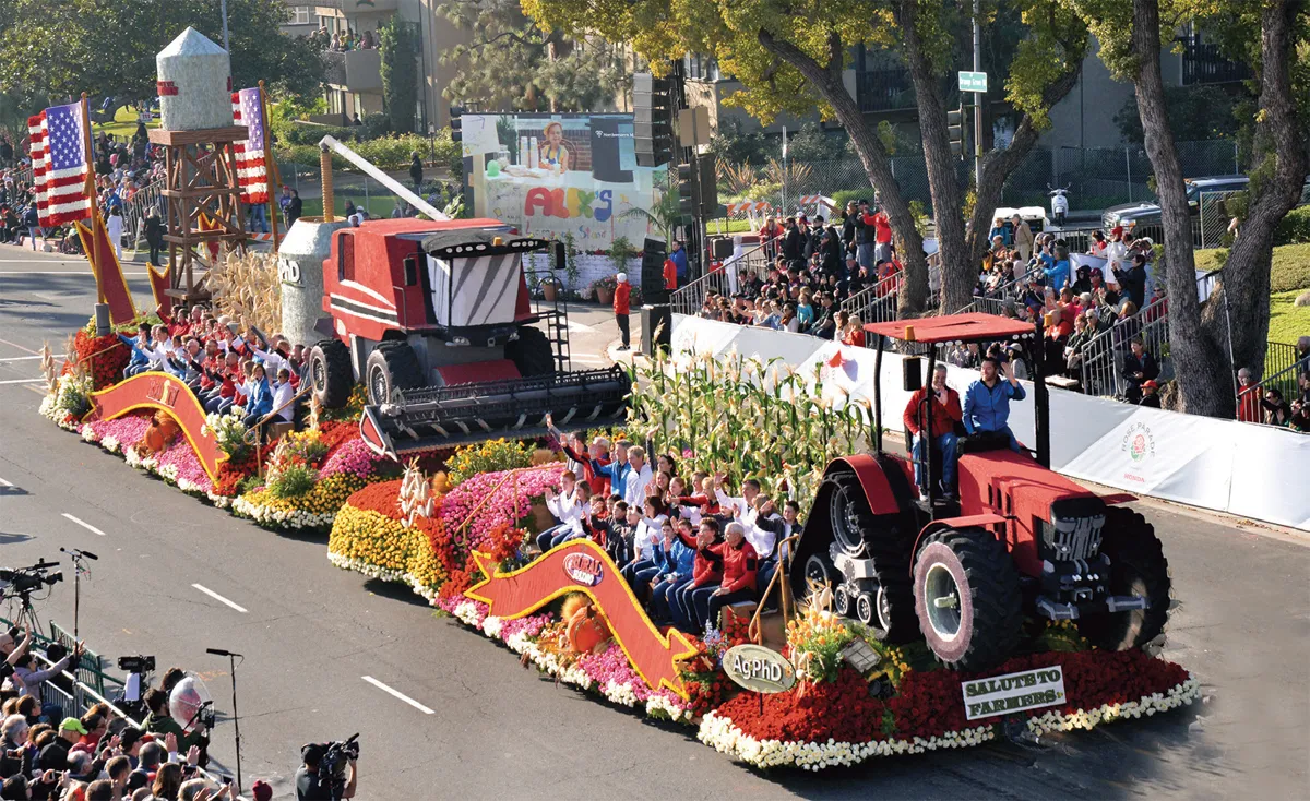 Floral parade float featuring a red tractor.
