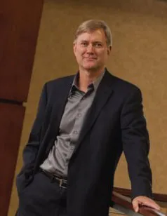 Dan Loveland standing with one hand in his pocket