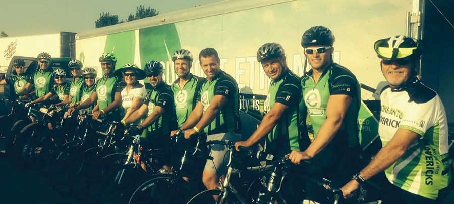Group of cyclists wearing helmets riding bikes together