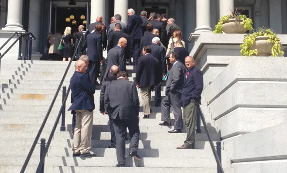 A group of people going up the stairs 