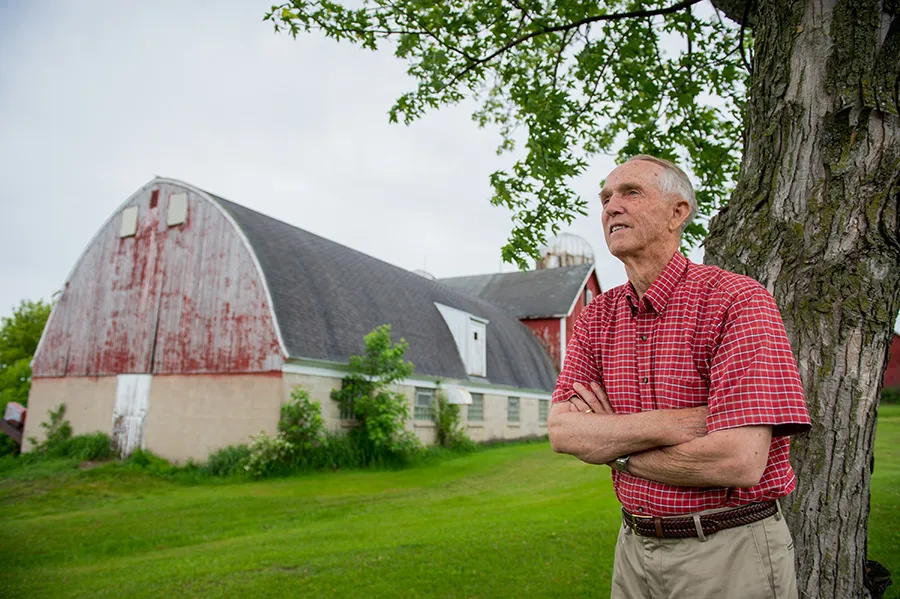 Lowell Broin standing by a tree