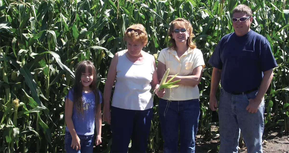 Bria Gallogly, Lois Gowing and Mary Gallogly with Rick Reber of Aberdeen, who farms the land and delivers the grain from the land to POET Biorefining – Groton.