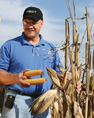 Darin holding corns on the farm