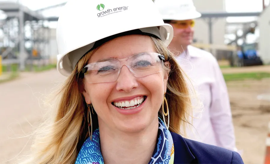 Emily Skor wearing safety glasses and hard hat smiling at the camera