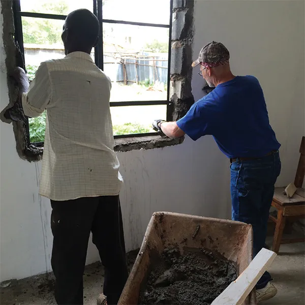 Jerry Nash helping install a window.