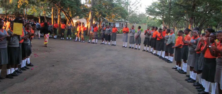 The girls from the school lining up to greet the team