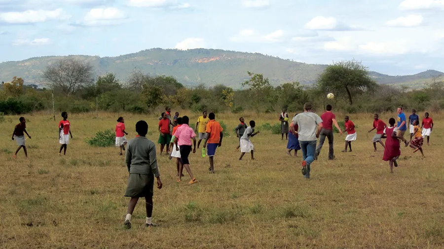 POET team members play soccer with the students at Travellers’ Oasis Centre.