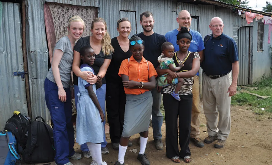 Katherine Veenis, Courtney Heitkamp, Suzanne Veenis, Brad Heggeseth and David Carlson visit the home of one of the TOC students.