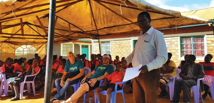 Timothy Mukilya, the headmaster of the school, speaks to the group.