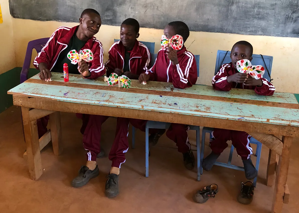 The students displaying their butterfly crafts