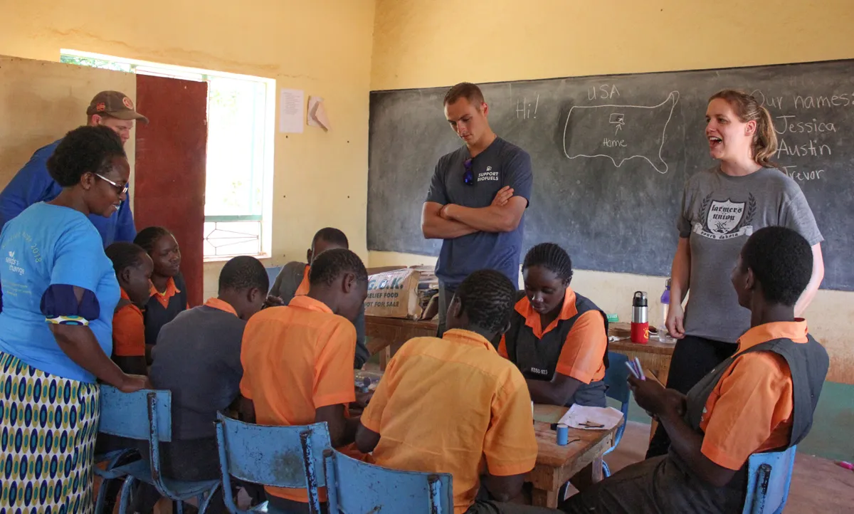 Trip participants working on a craft with the students in the classroom