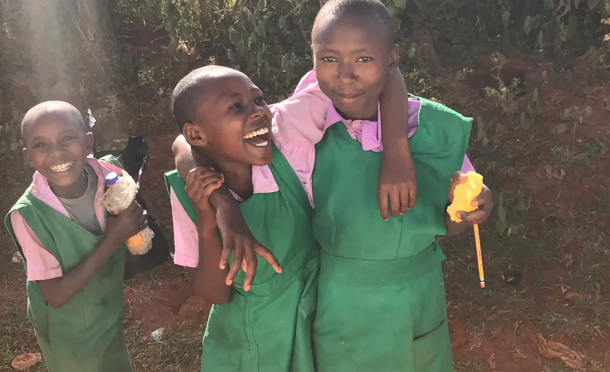 Kids from the community share smiles.