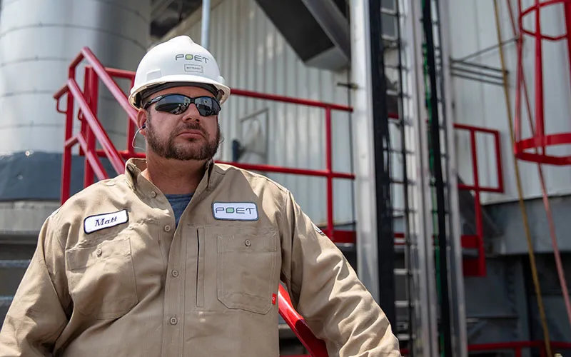 Headshot of Matt Pedersen outdoors in front of a factory