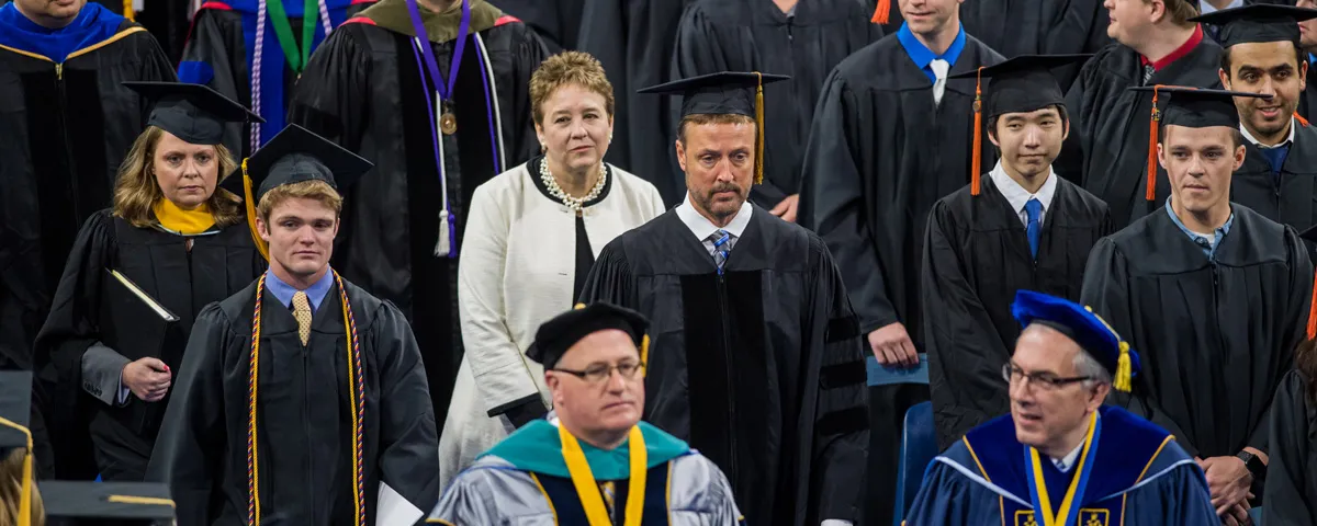 Students wearing uniforms at graduation