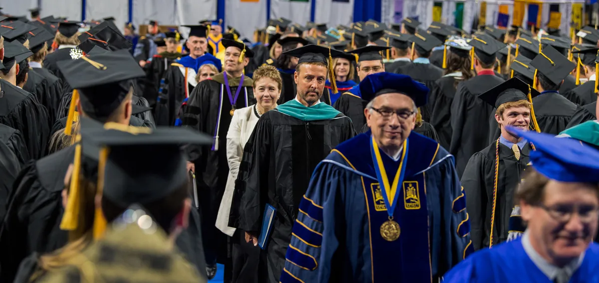 Students wearing uniforms at graduation