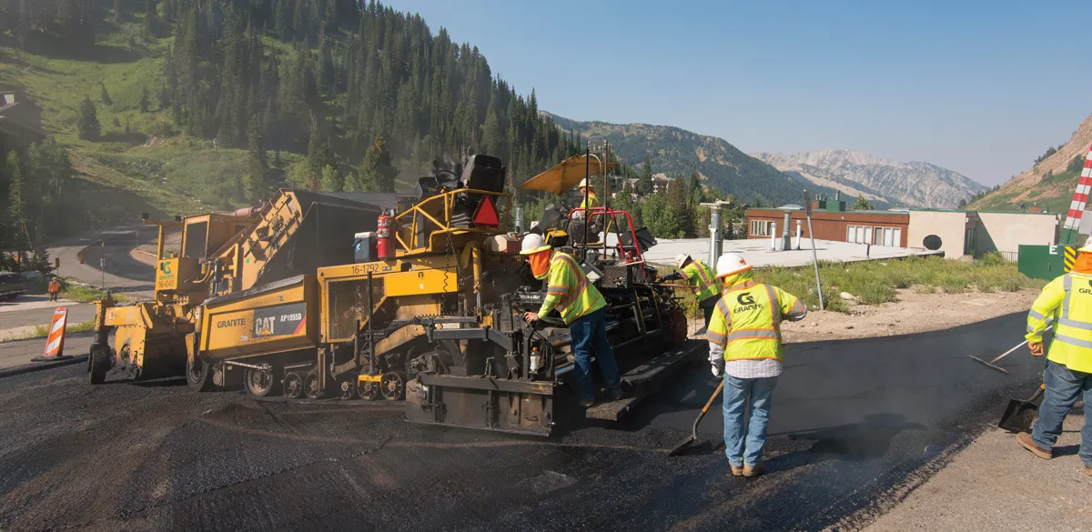 Road workers paving asphalt