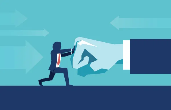 Businessman pushes against giant hand
