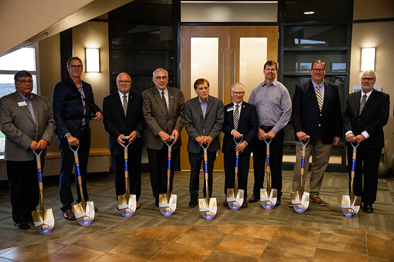 A group of people holding shovels