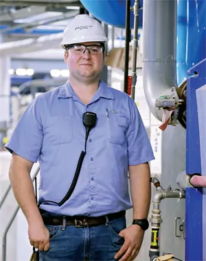 Ben standing in a factory 