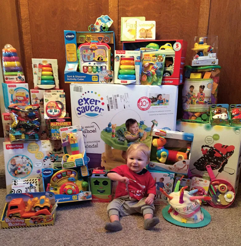 A kid sitting in front of toys 