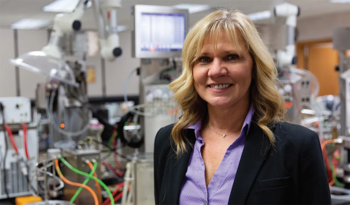 Gwen Biersbach standing in a lab