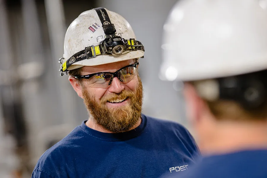 Jed smiling to a colleague