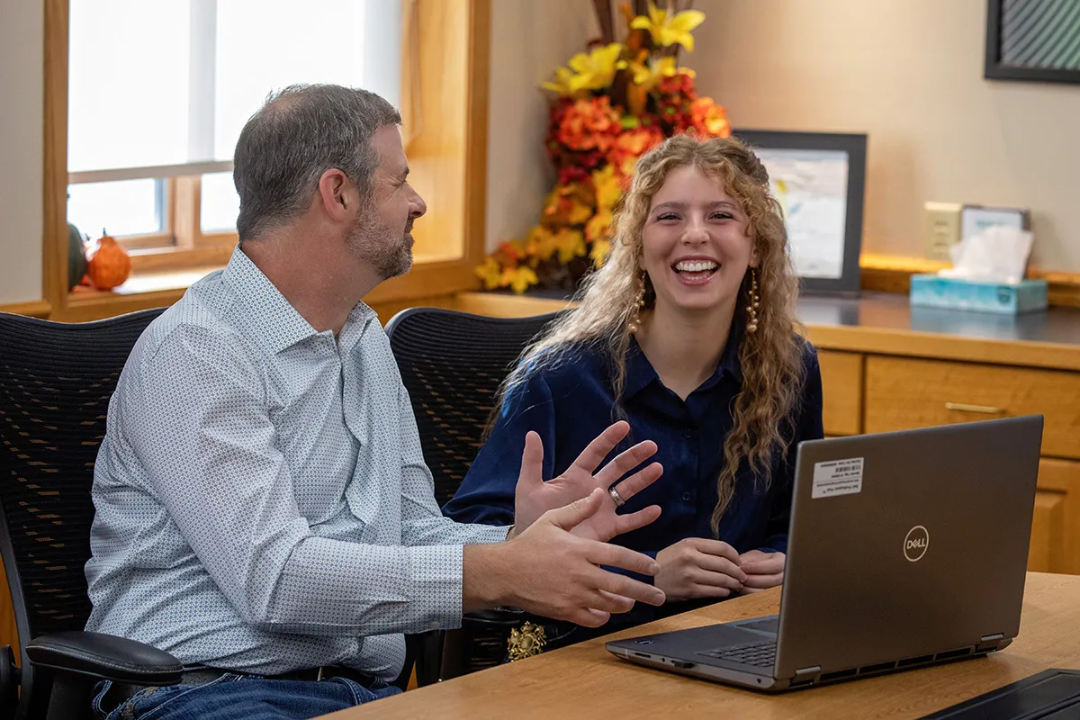 Charles and his daughter in the office