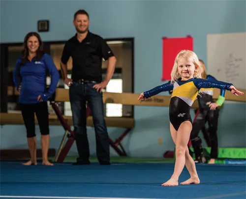 Alicia and Matt Reiners watch daughter Harper practice at Wing’s Gymnastic Academy.