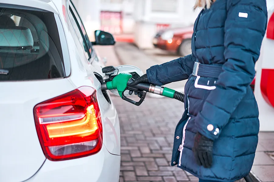 A person refueling a car at a gas station