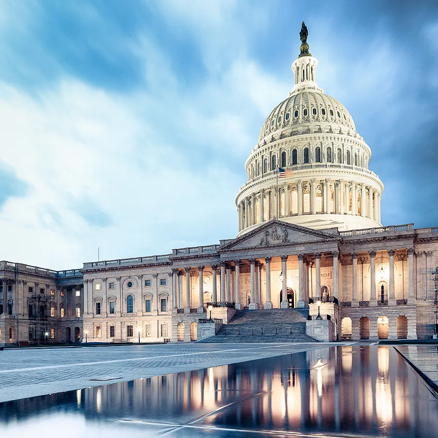 Capitol dome at dusk with reflecting pool