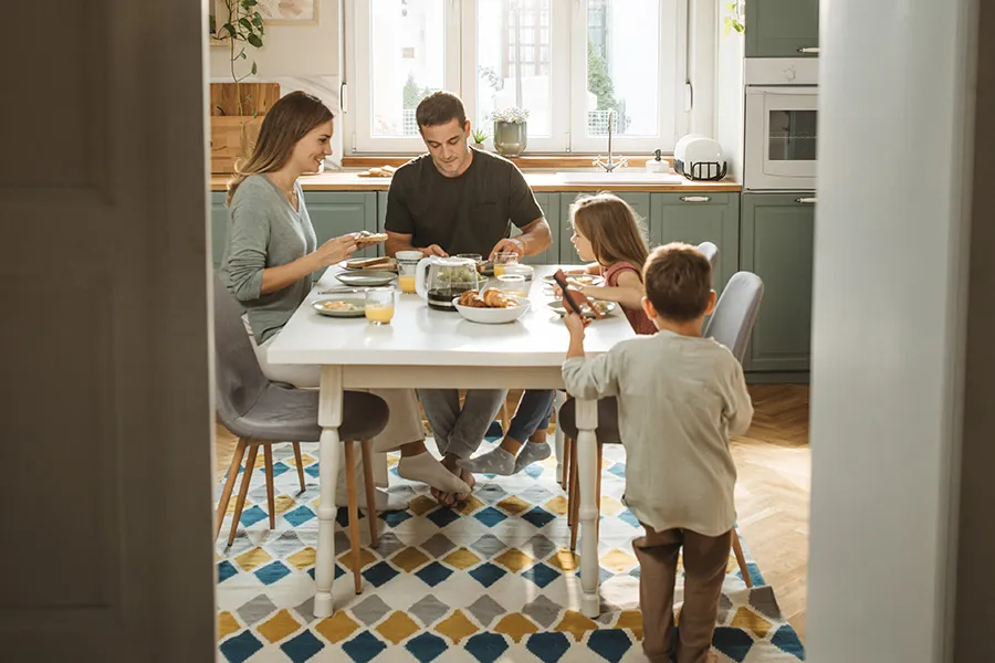 A family of four having food at the kitchen